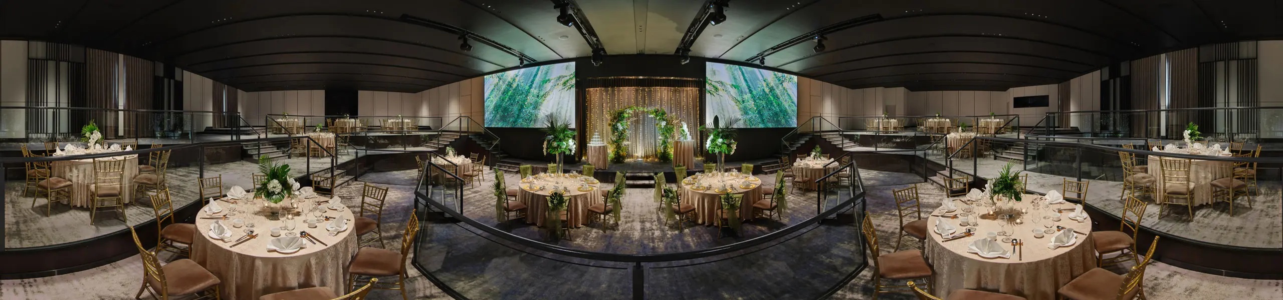 Hilton Singapore Orchard wedding ballroom with round tables, floral arch, fairy lights, and tropical LED screens on stage