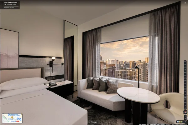 Google hotel virtual tour of Hilton Singapore Orchard room with king bed, mirror, floor lamp, and city view